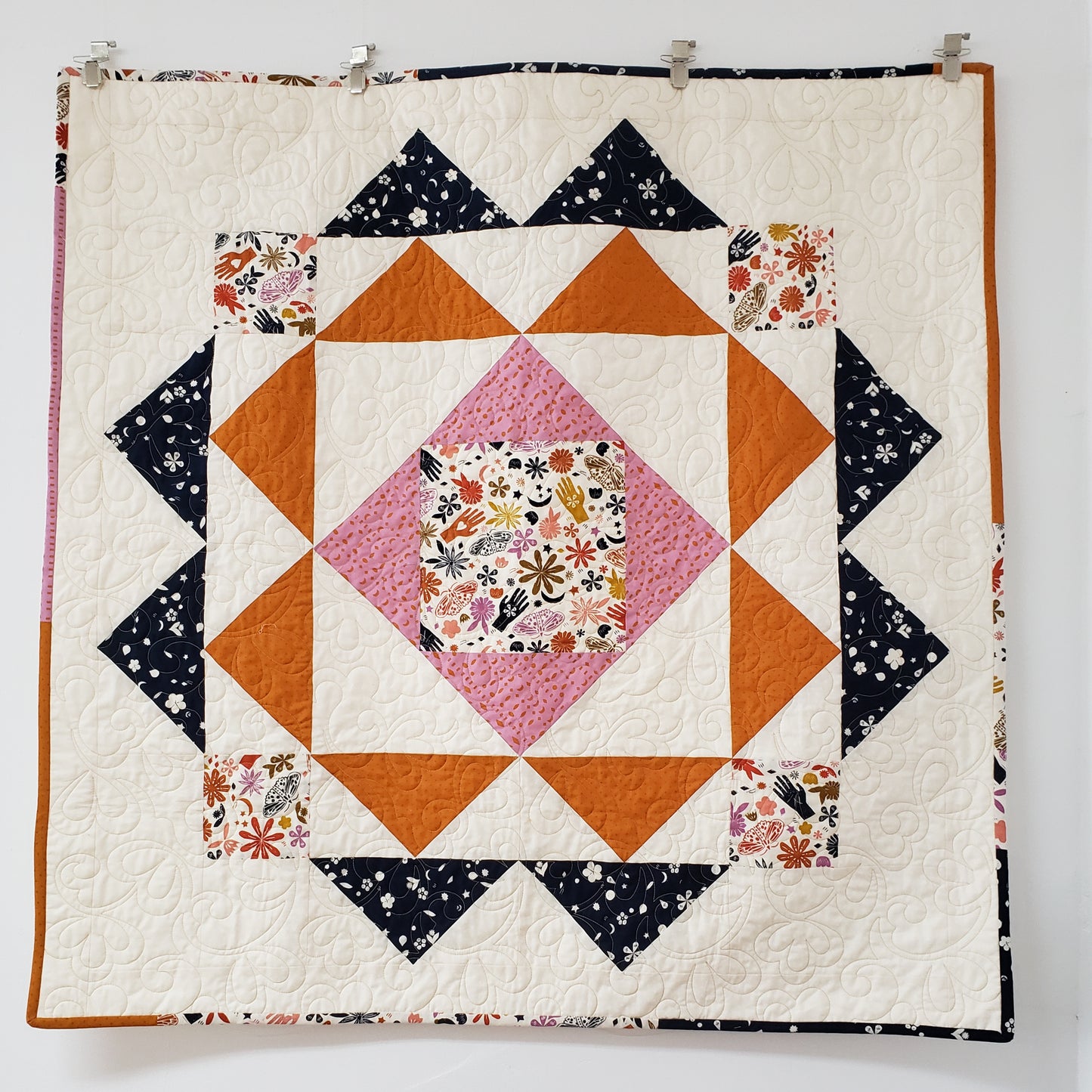 baby quilt ivory with blue and orange triangles