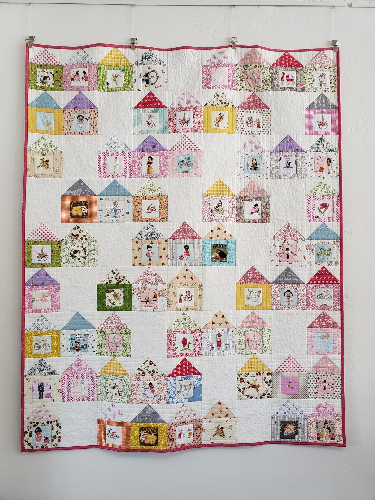 Quilt with houses and fussy cut images in doors