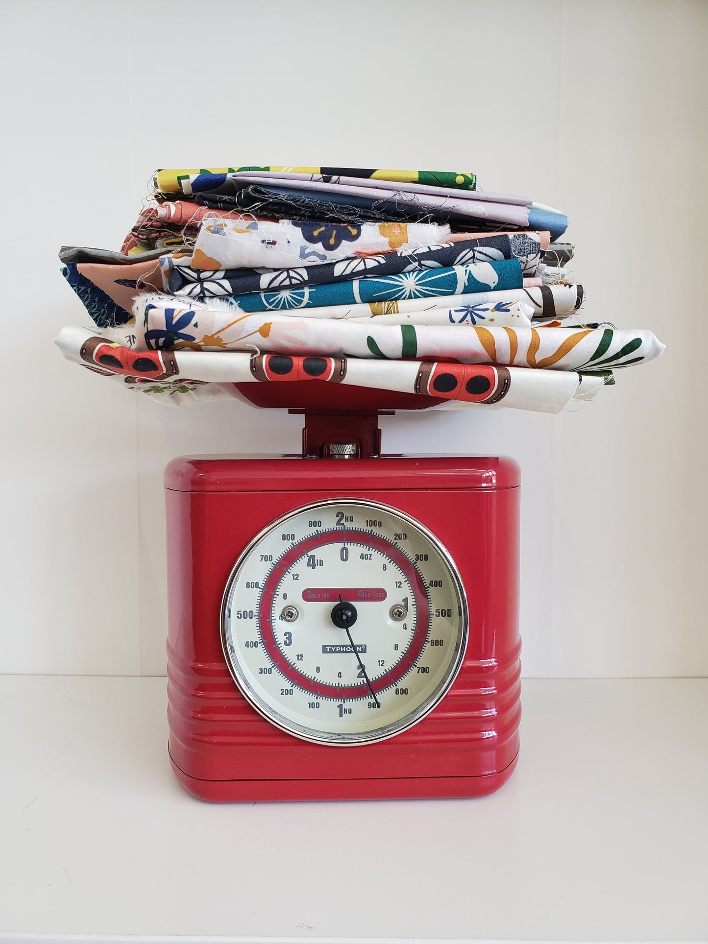 stack of fabric on a red scale showing 2lbs of weight