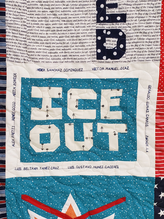 Textile art piece with text on a blue background, surrounded by various patterns and colors.