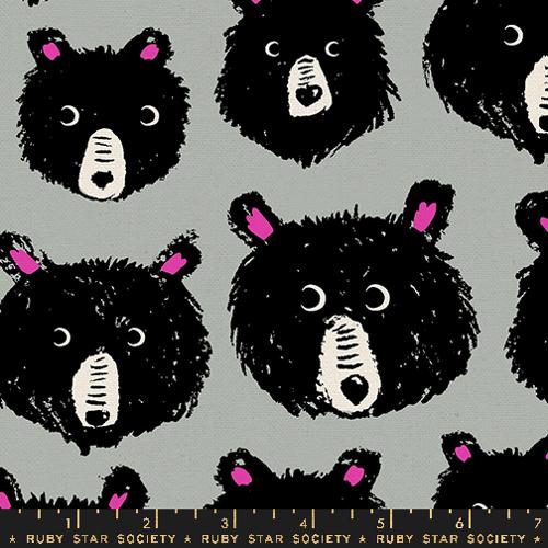 a close up of tan fabric with black and pink bear faces
