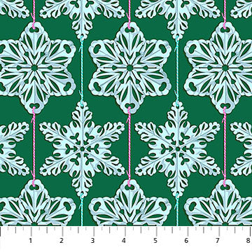 Pattern of snowflakes on a green background with a ruler at the bottom.