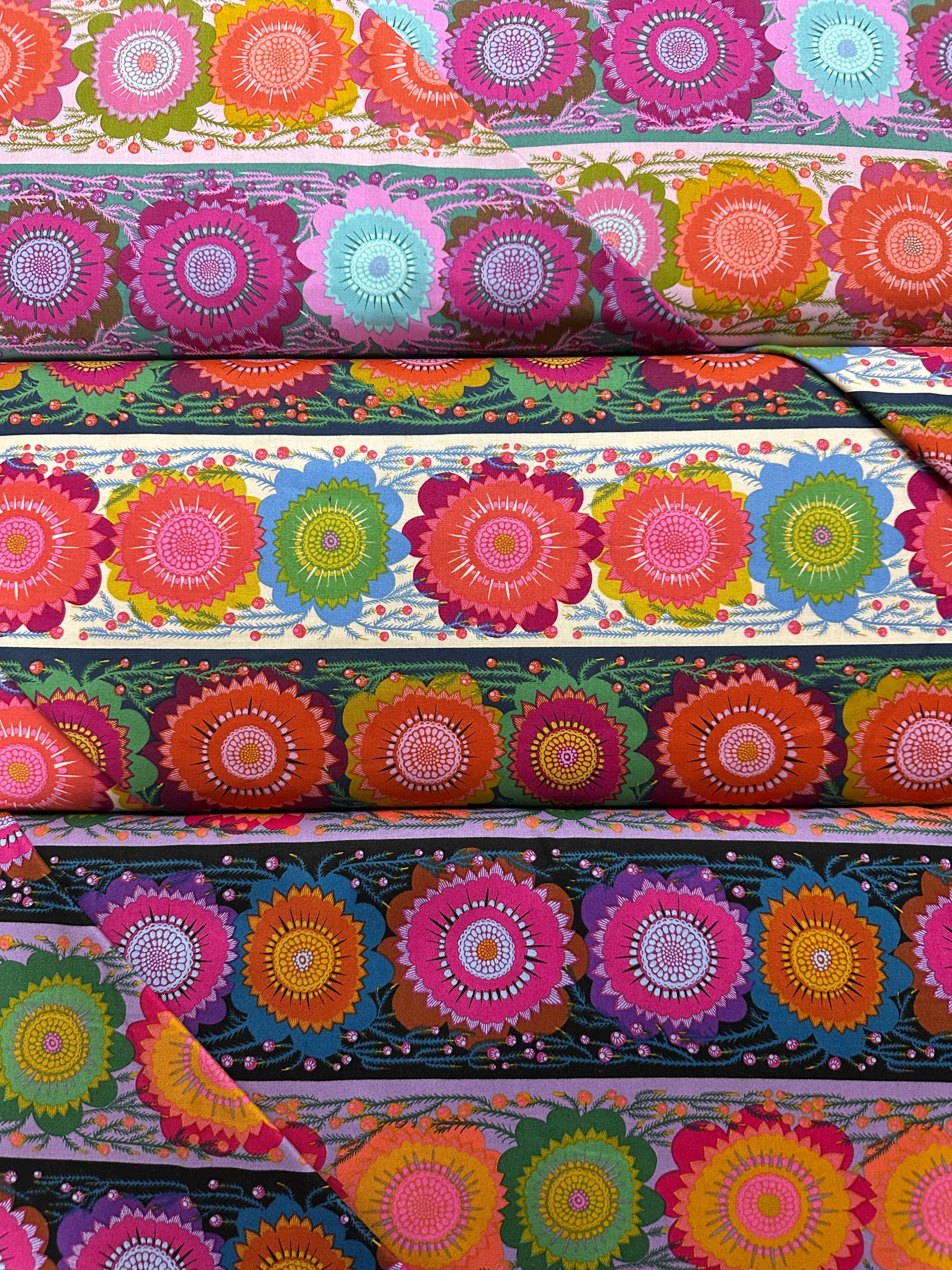Colorful floral patterned fabric swatches arranged vertically.