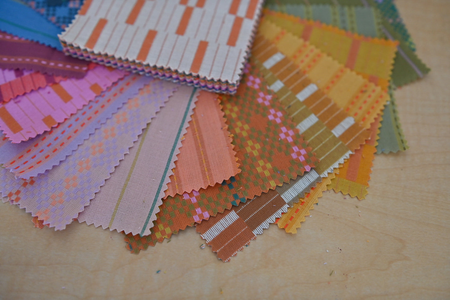 Color swatches with various patterns on a wooden surface