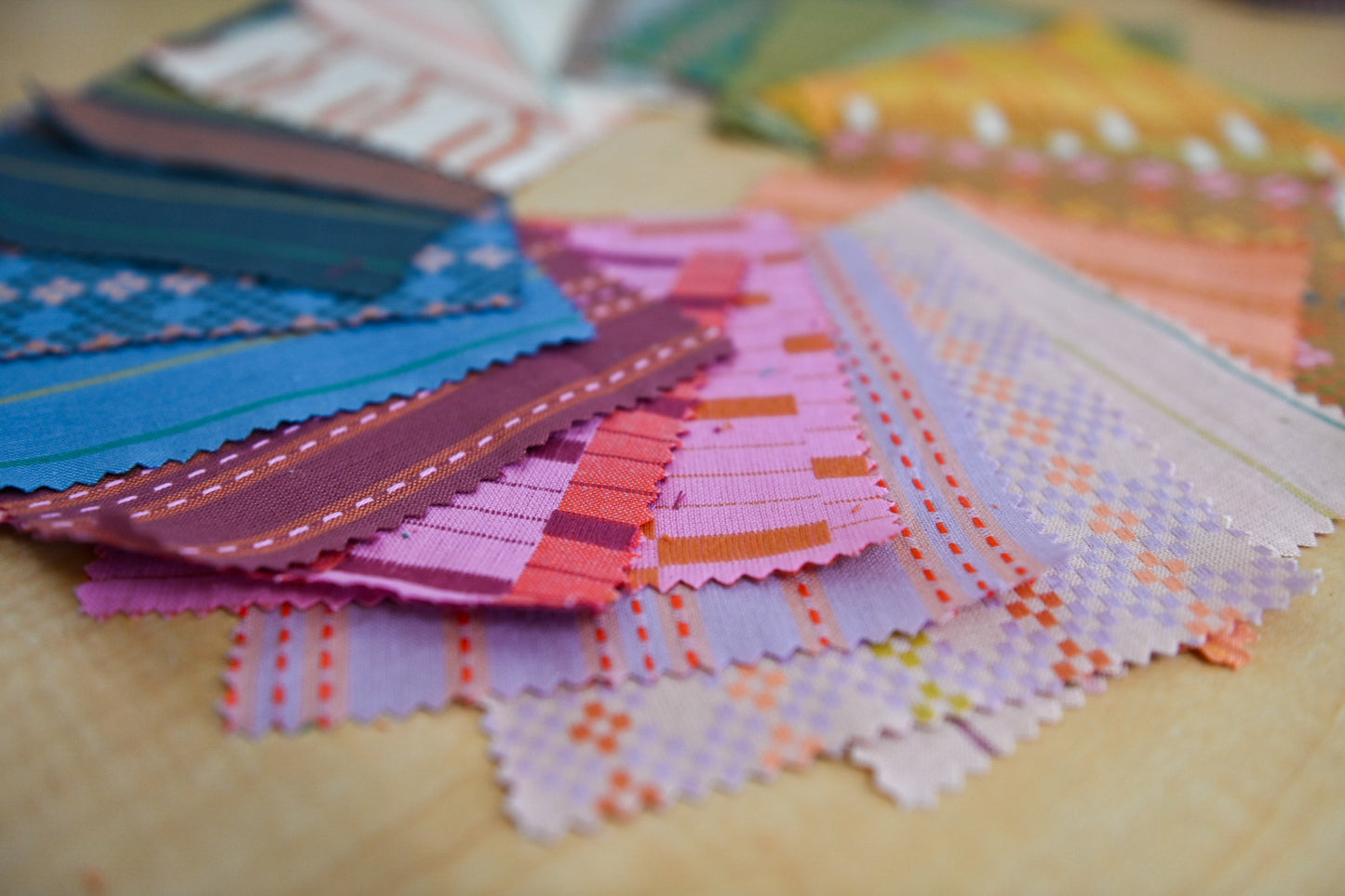 Color swatches with various patterns and colors on a wooden surface