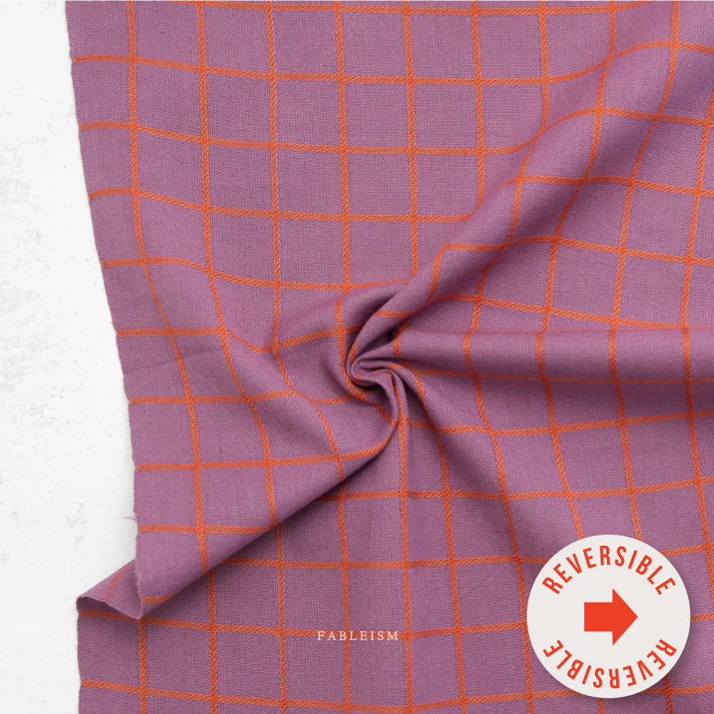 Purple fabric with orange grid pattern and 'Fableism' branding on a white background