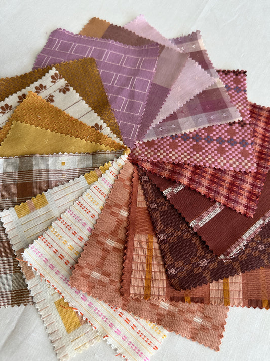 Golden Hour fabric close up featuring pink, red, gold and white fabrics arranged in a colorful circle