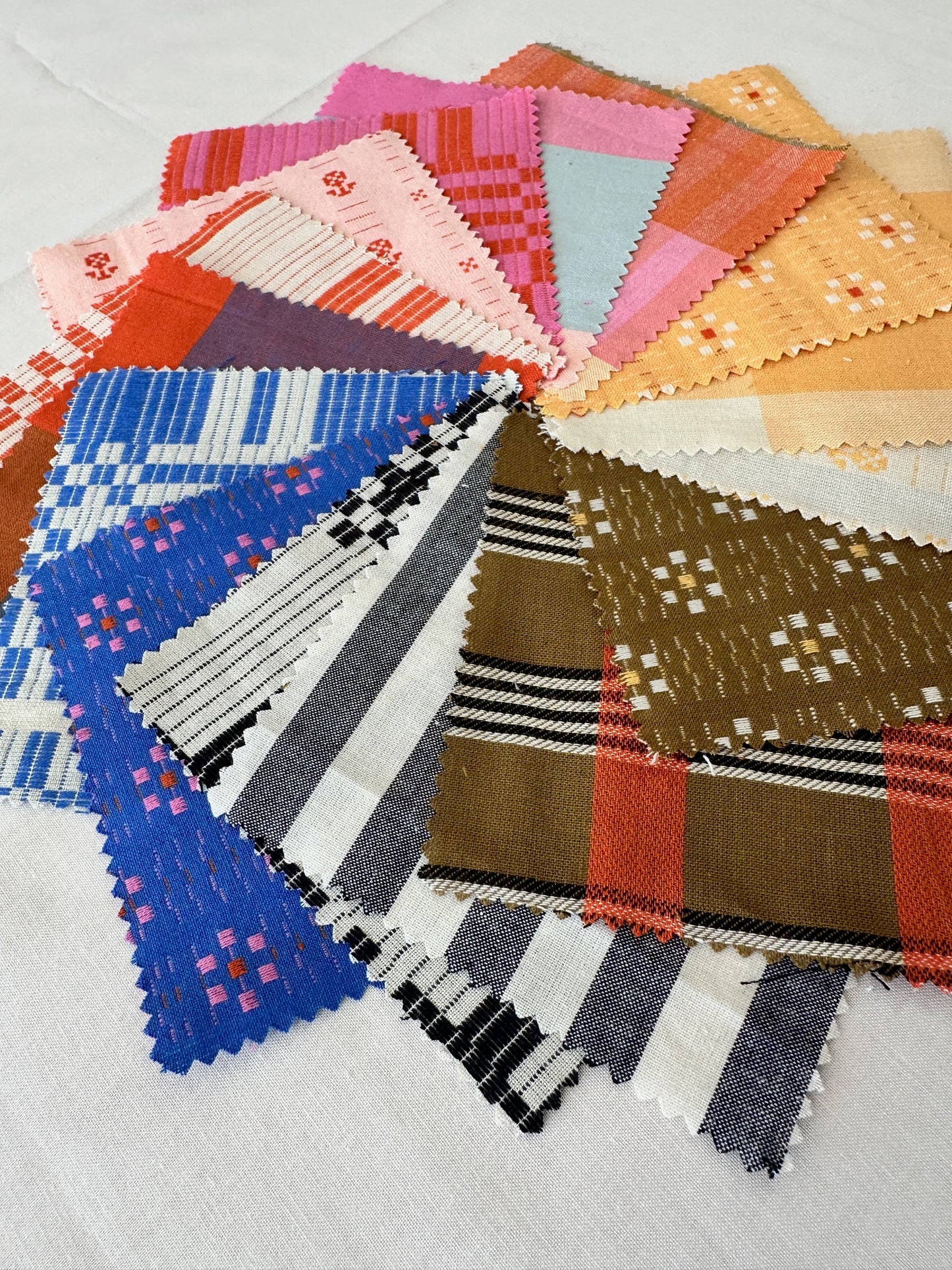 House of Lars close up featuring colorful fabrics in blue, pink, yellow, brown and black and white
