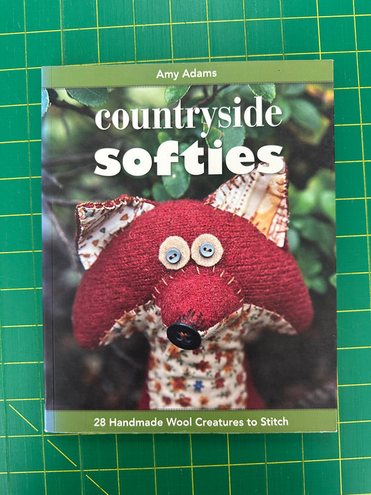A book titled Countryside Softies on a green cutting mat