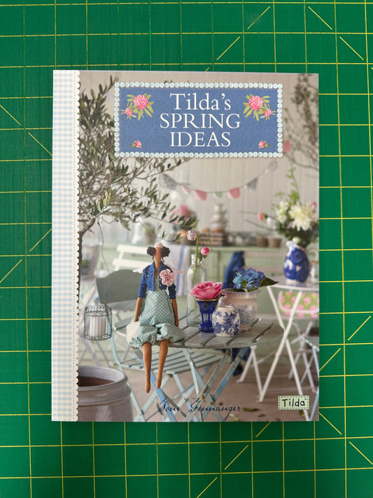 Book titled 'Tilda's Spring Ideas' on a green cutting mat
