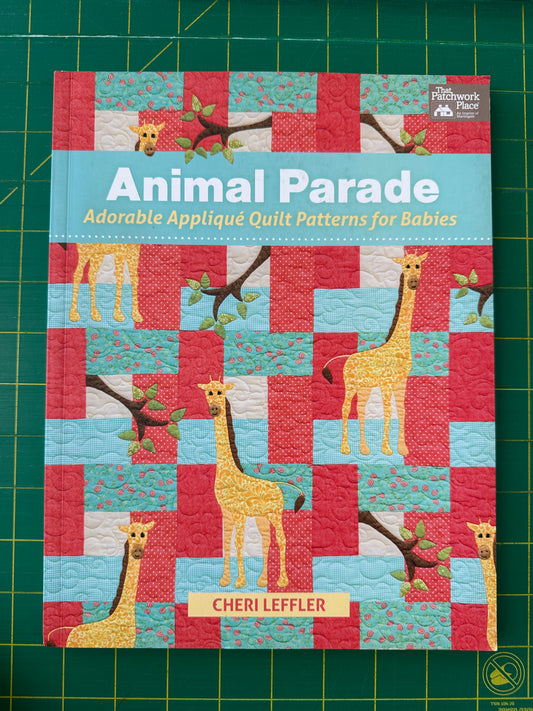 Book cover of 'Animal Parade' with giraffe illustrations on a checkered pattern