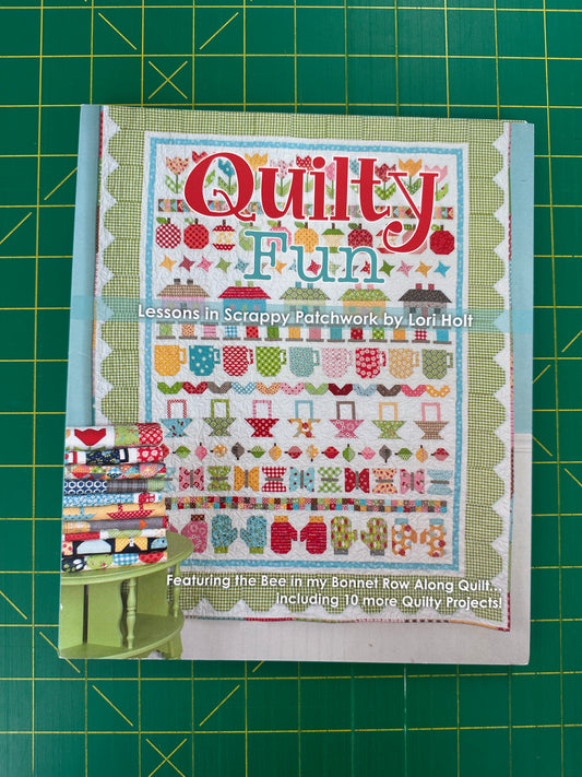 Quilt pattern book on a green cutting mat