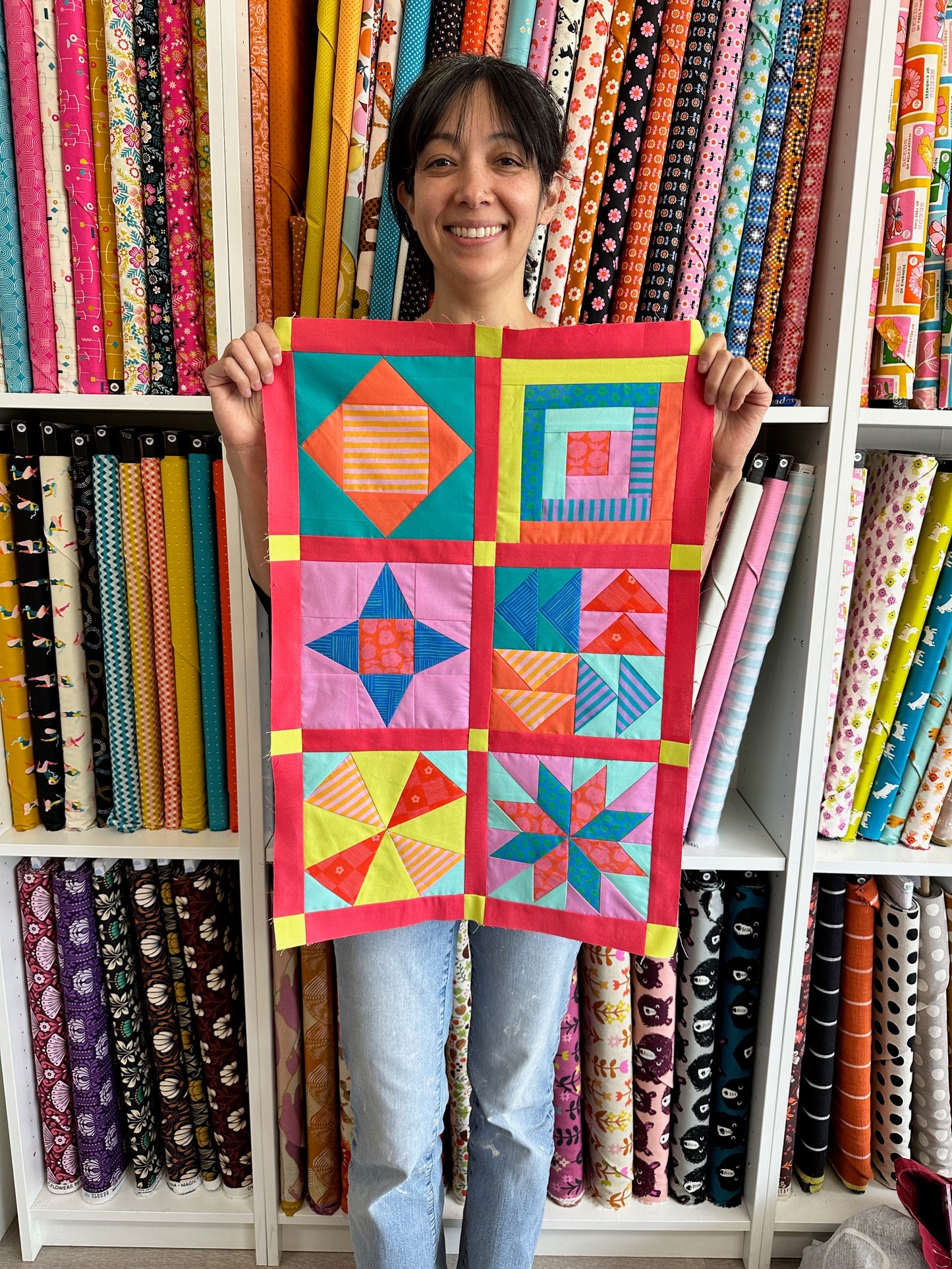 Mikka holding mini sampler quilt