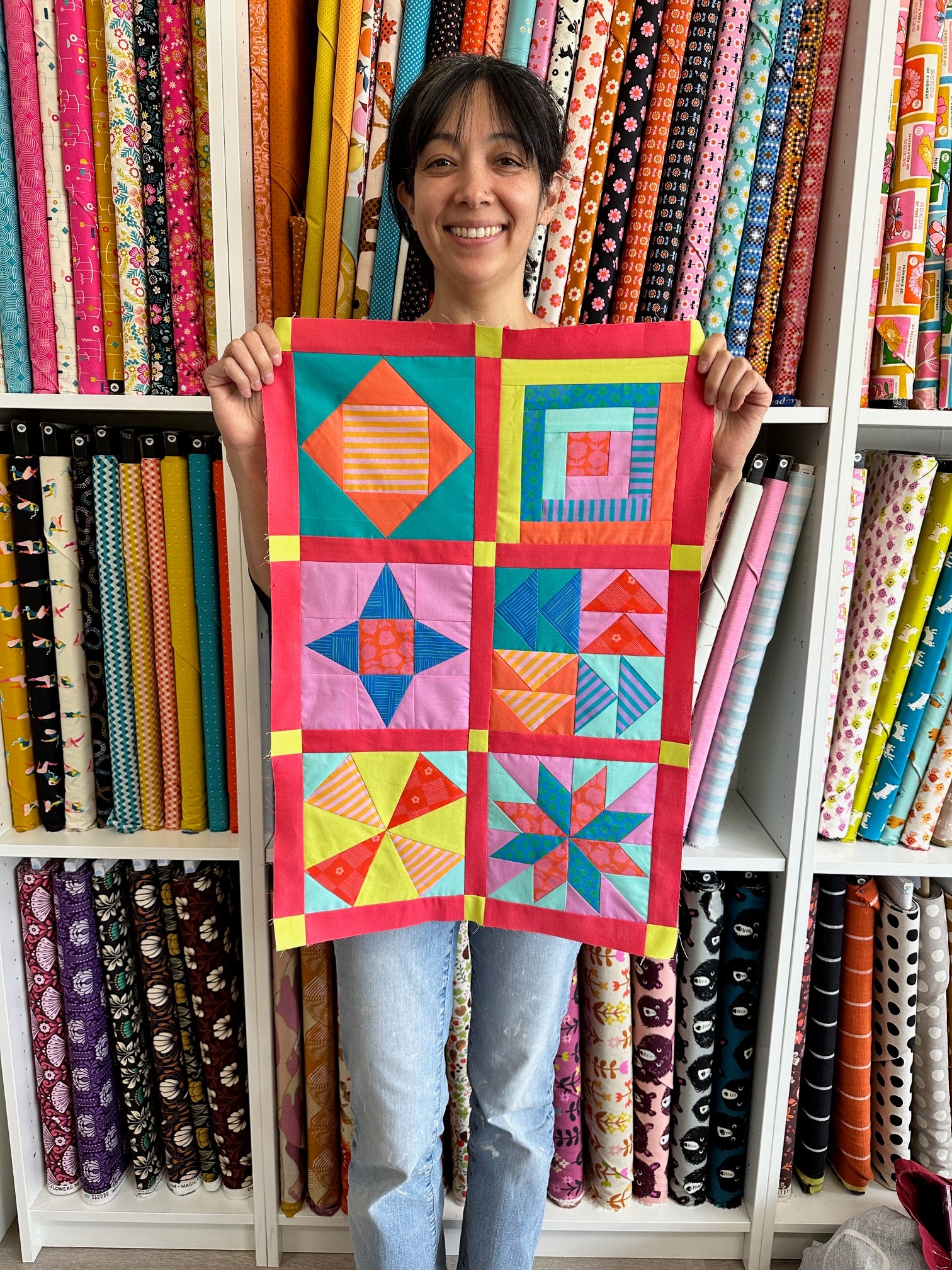 Mikka holding mini sampler quilt