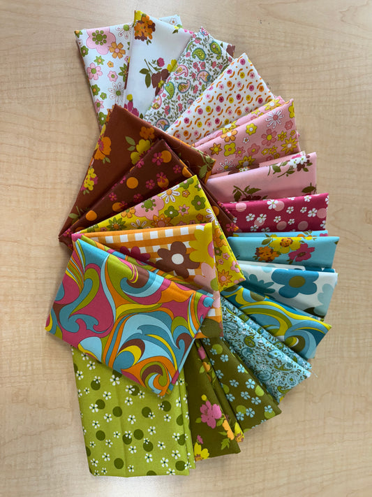 Collection of colorful fabric swatches arranged on a wooden surface