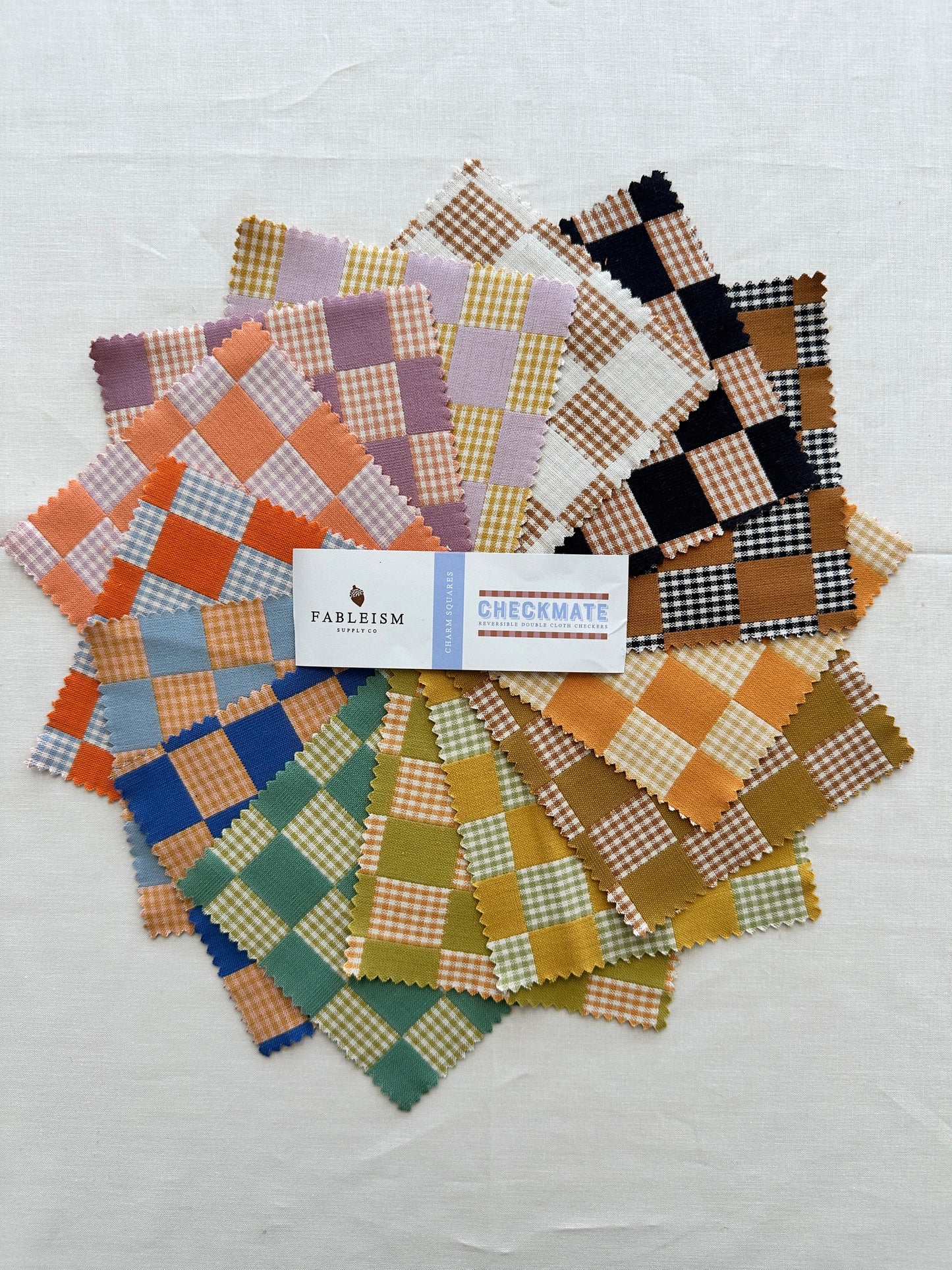 Fableism Checkmate Fabric arranged in a colorful slay of checkered fabric