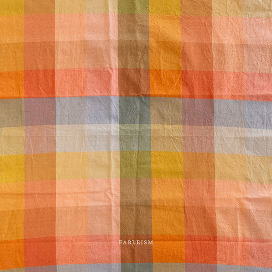 Checkered fabric with autumnal colors and 'Fableism' branding.