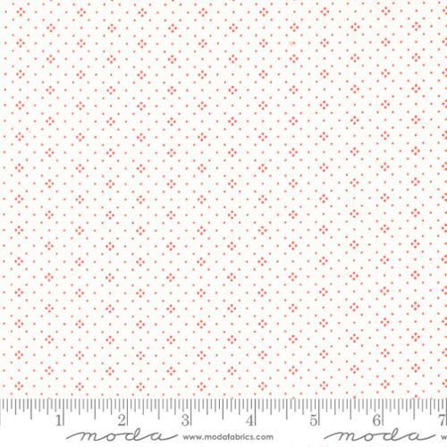 Fabric pattern with small red stars on a white background, featuring Moda label.