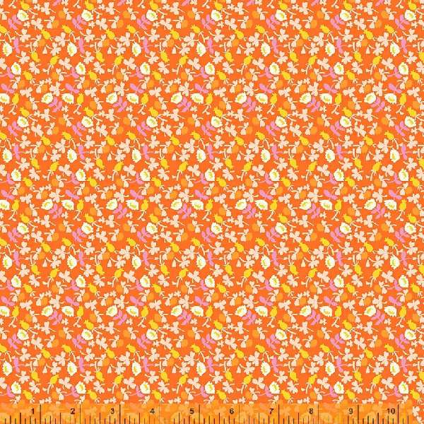 A calico fabric with small white flowers with orange, pink and yellow accents, against an orange background