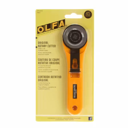 OLFA rotary cutter on a yellow packaging background