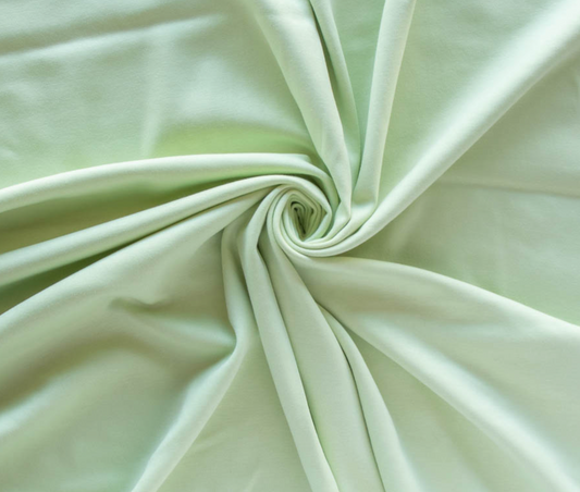 Close-up of light green fabric with a swirl pattern