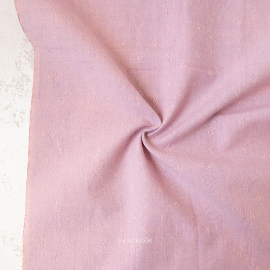 Pink fabric with a subtle texture on a light background