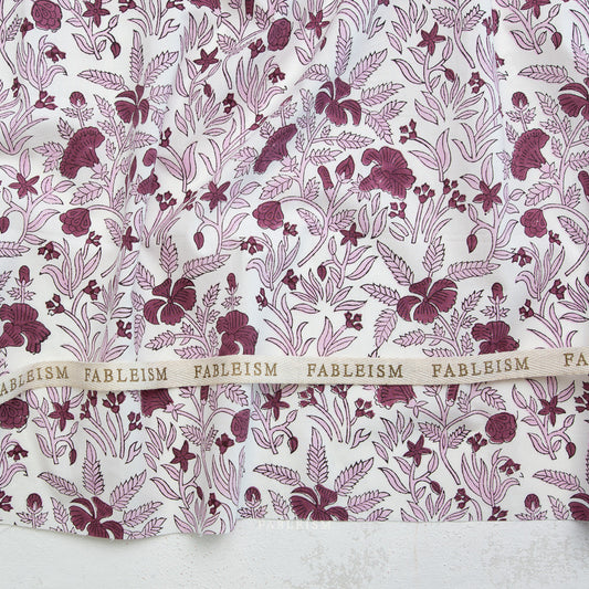 Fabric with a floral pattern and 'Fableism' branding.