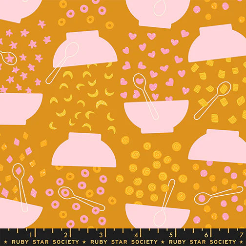 Pattern of pink bowls and spoons on a mustard yellow background with hearts and stars, Ruby Star Society label at the bottom.