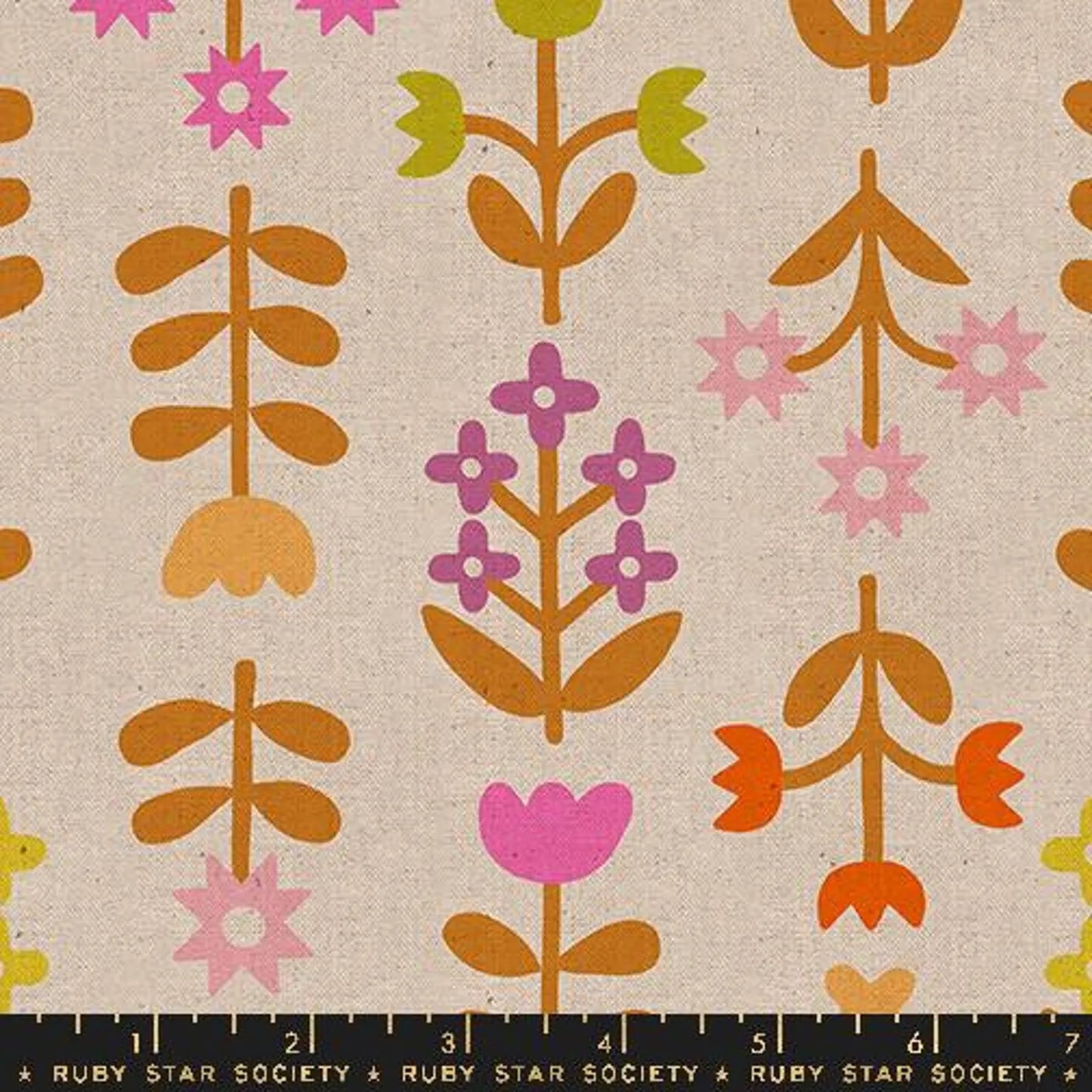 A close up of tan fabric with a brown, green and purple floral print
