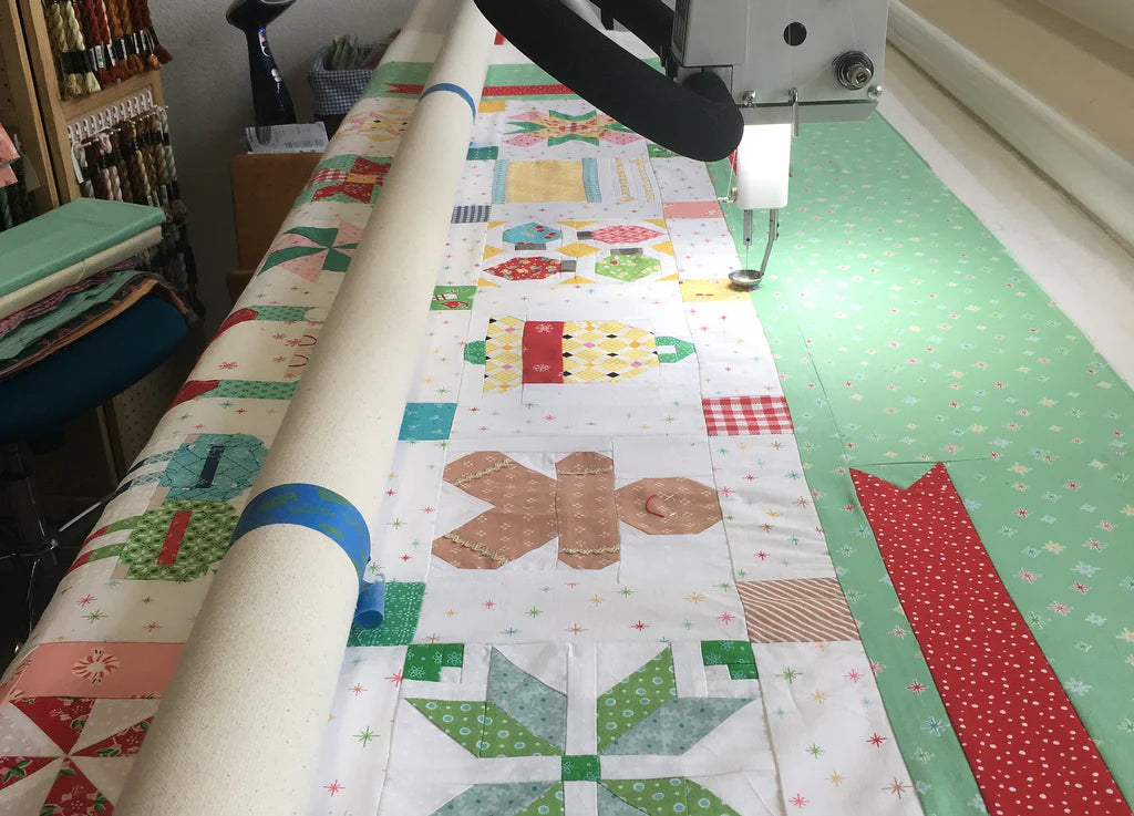 We provide Longarm services! This is a picture of a quilt being longarmed