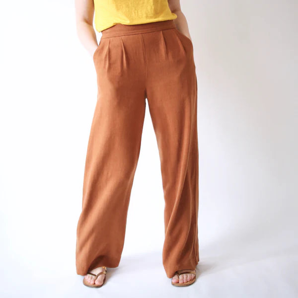 Brown wide-leg pants worn by a person on a white background