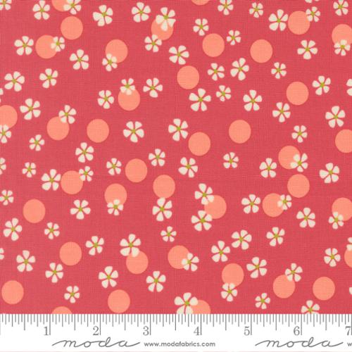 White flowers and pink dots on a dark pink background with the Moda ruler below