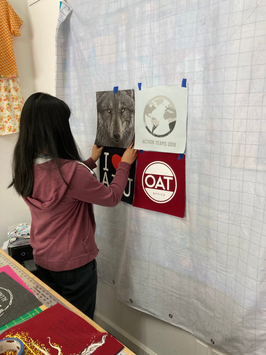 a young person is lining up t-shirt blocks