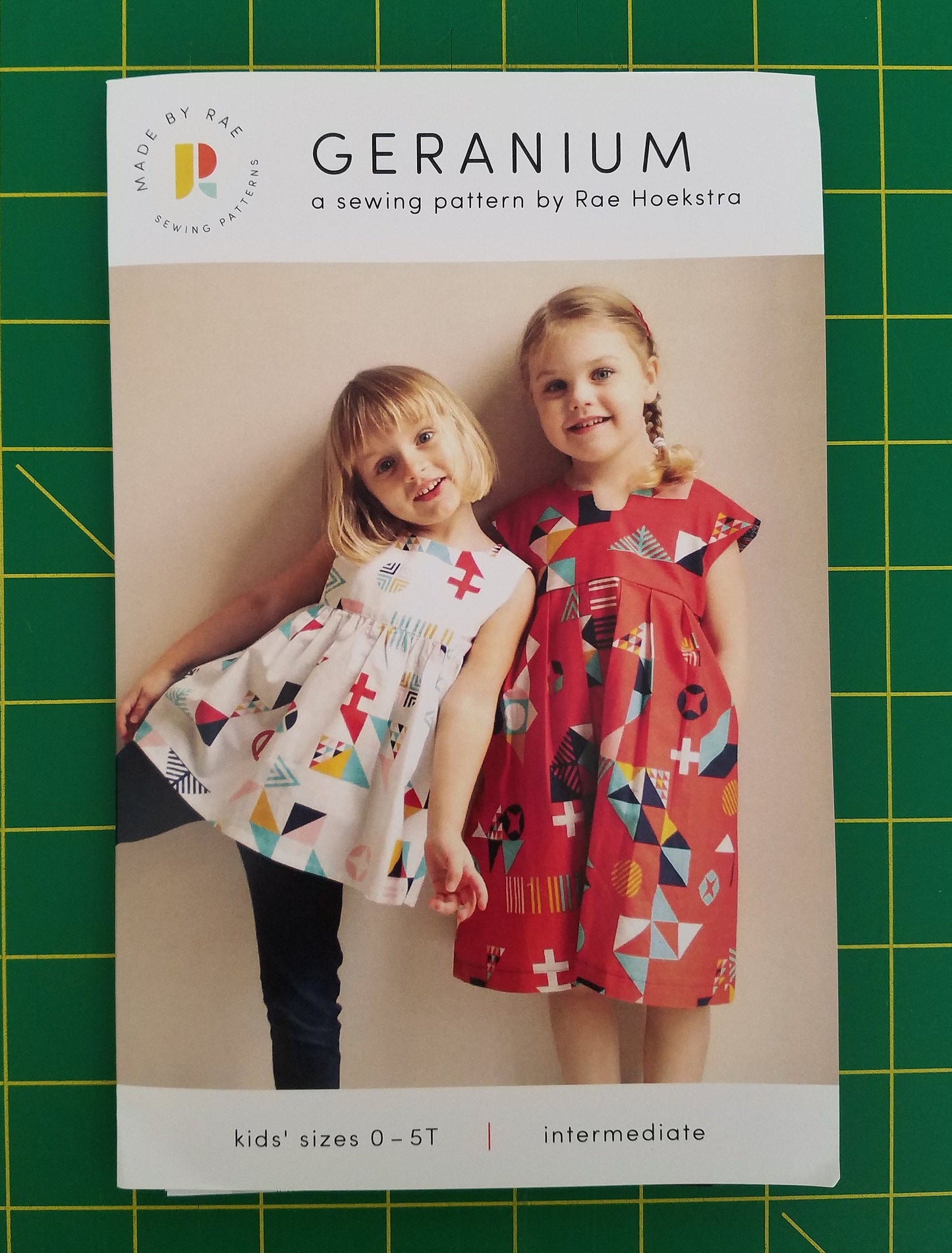 Sewing pattern on a green grid background