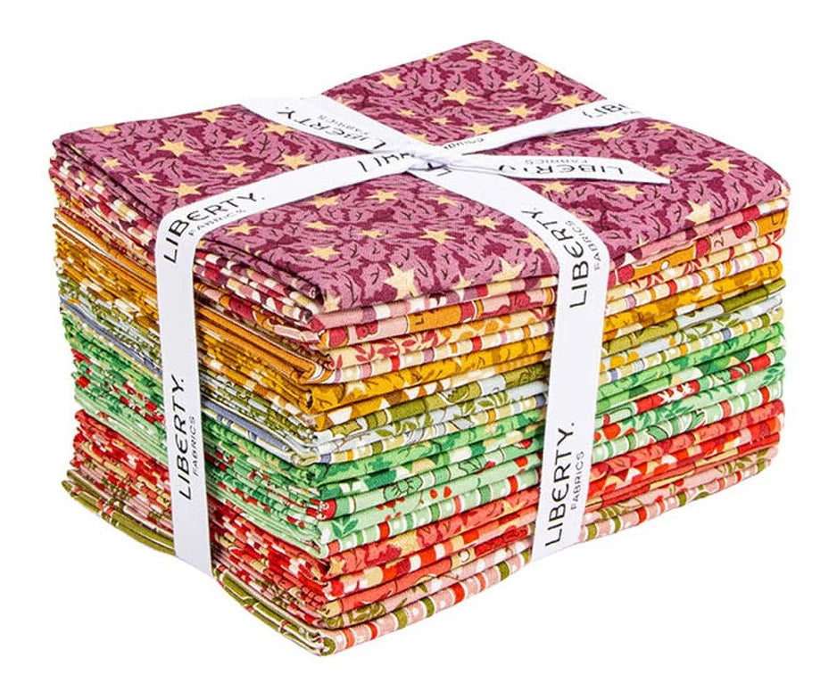 A bundle of Liberty fabric cutters tied with a white ribbon, showcasing a variety of colorful patterns including floral, stripes, and stars.
