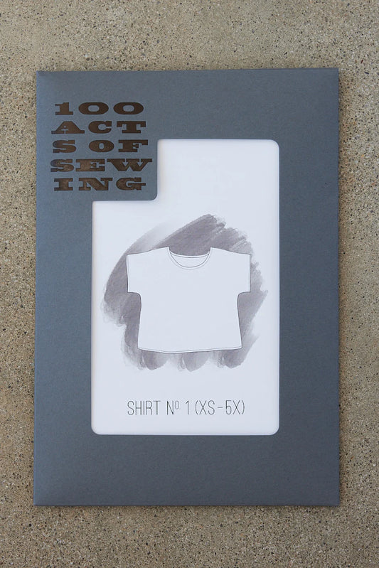 Sewing pattern packing with '100 Acts of Sewing' text and a shirt design on a gray background