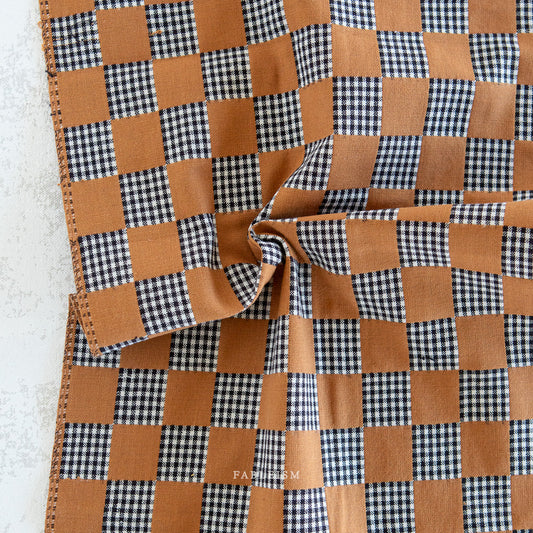 Checkered fabric with light brown and black and white pattern.