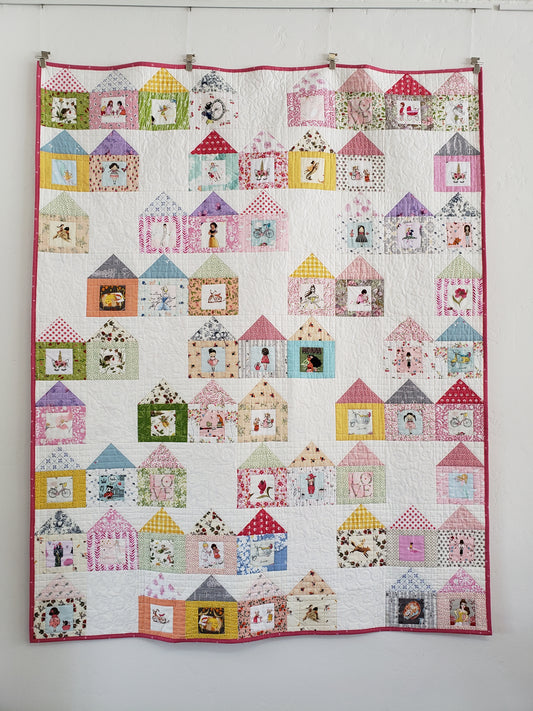 Quilt with houses and fussy cut images in doors