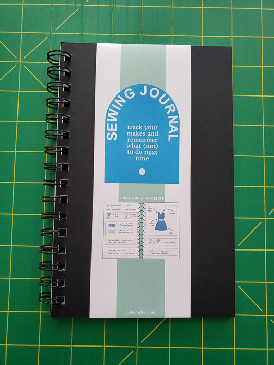 black notebook with descriptive band titled Sewing Journal