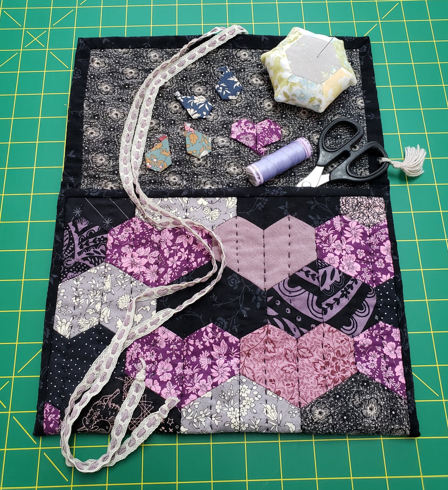 Hand stitched hearts quilted pouch opened with sewing tools