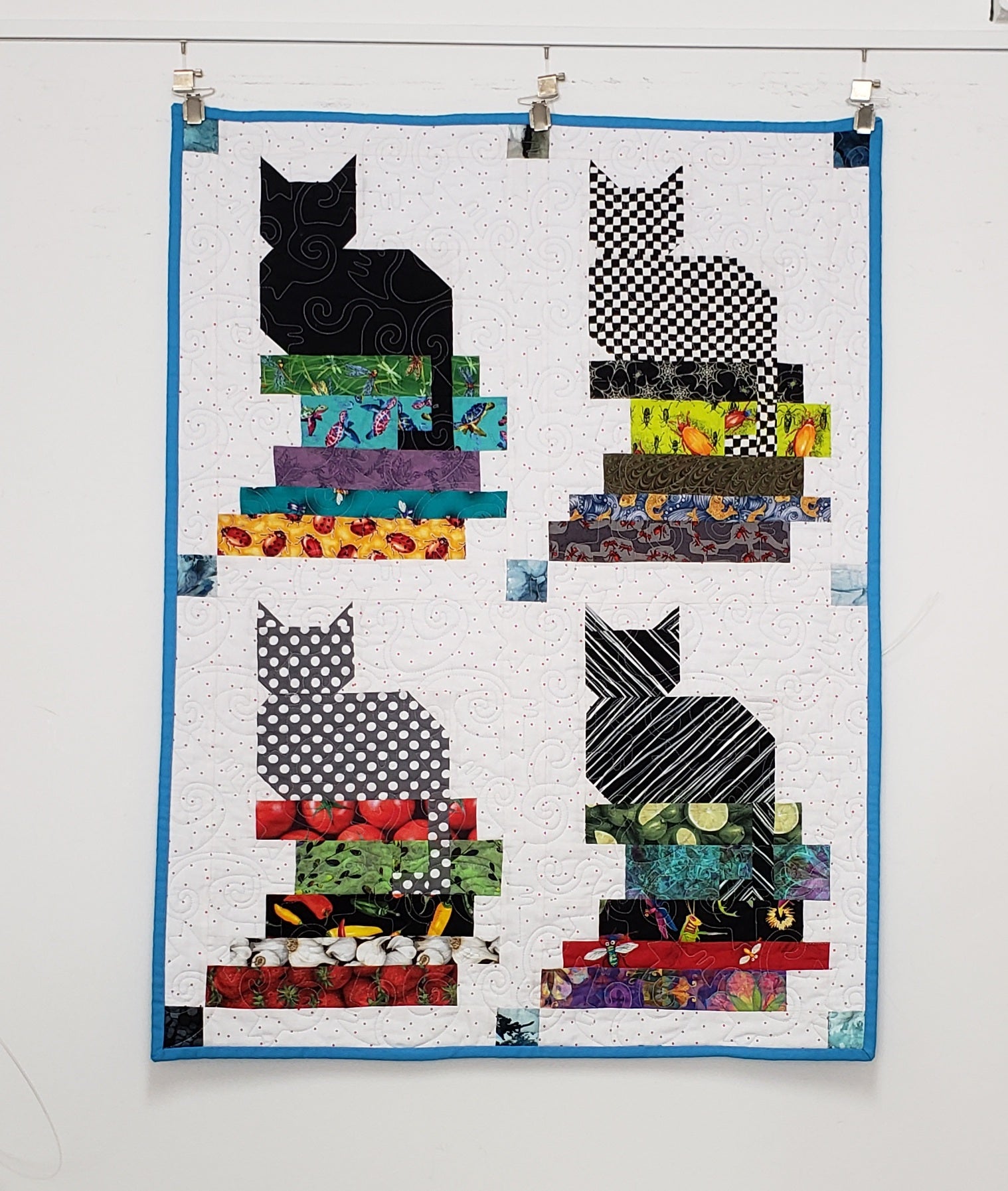 quilt with cats on books