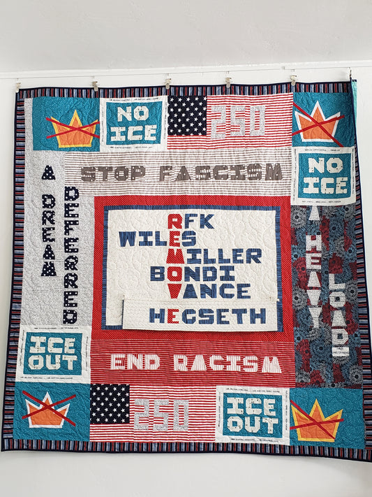Quilt with political-themed text and graphics on a white background