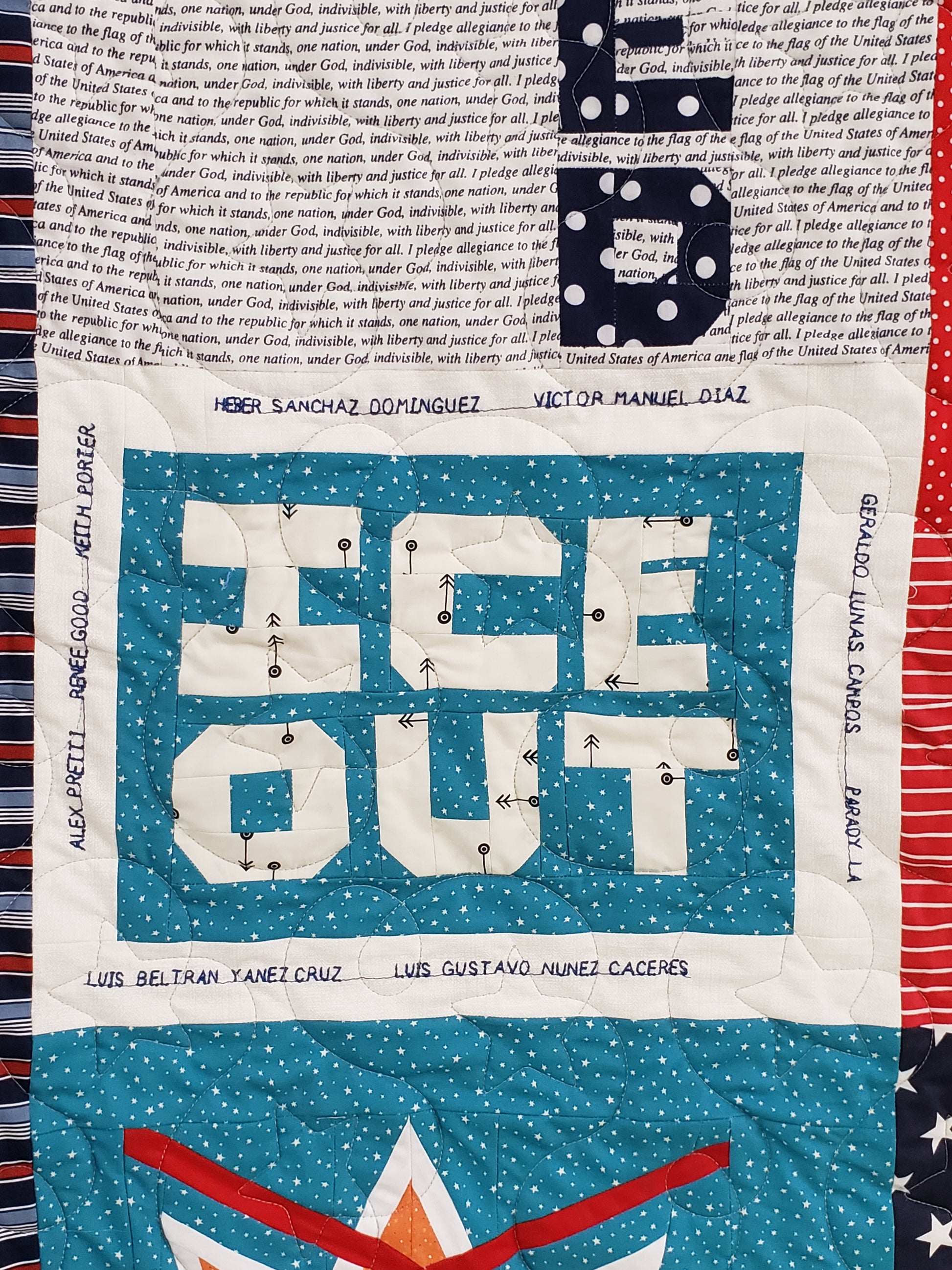 Textile art piece with text on a blue background, surrounded by various patterns and colors.