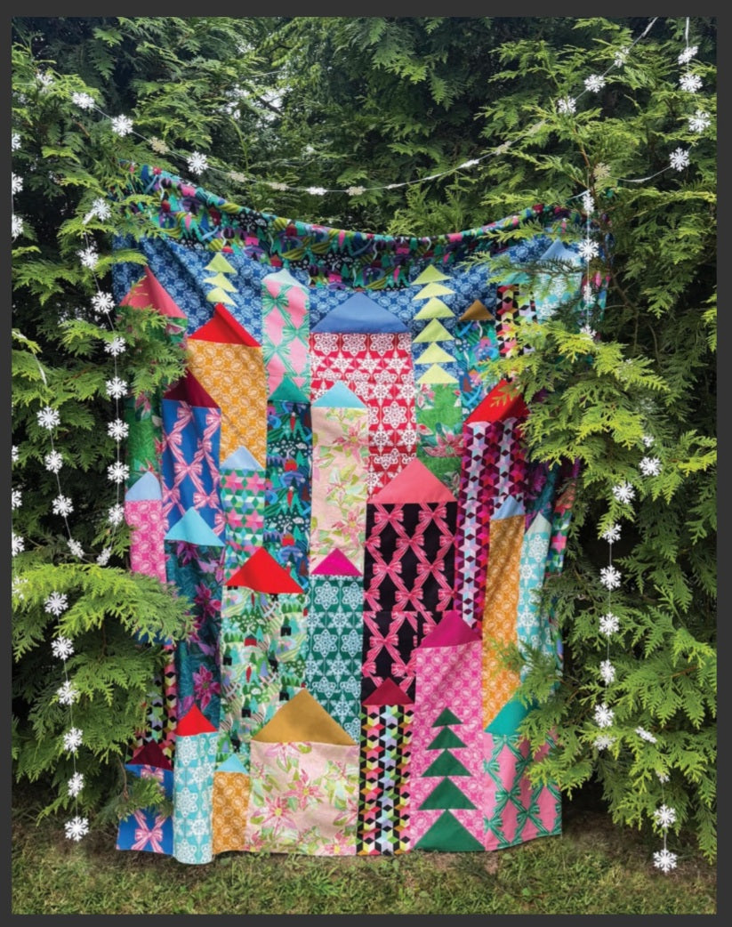 colorful quilt among trees and garland