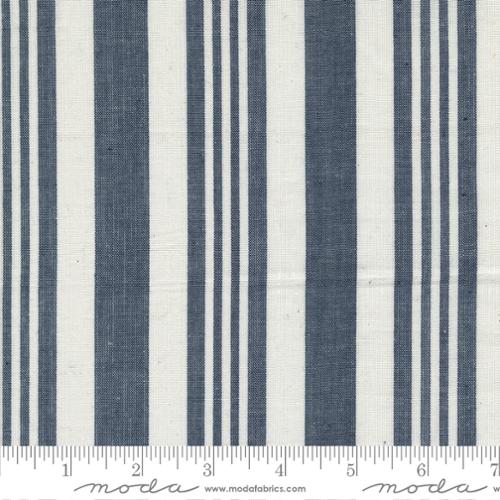 Fabric with blue and white vertical stripes on a white background, featuring Moda label.