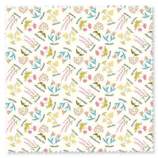 white fabric with brightly colored herbs and green cursive writing 