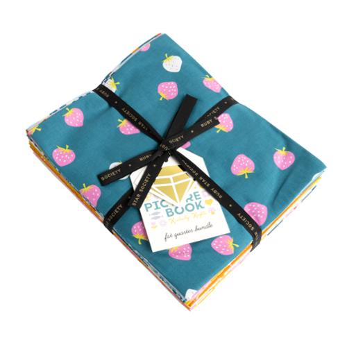 fabric stack in blues, pinks and yellows with  fruit prints