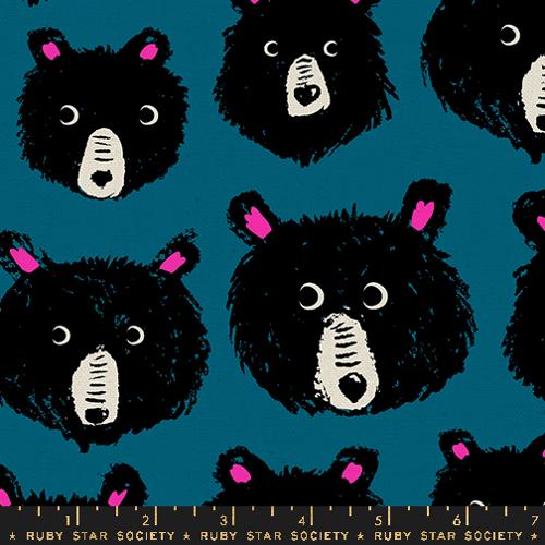 A close up of blue fabric with black and pink bear faces 