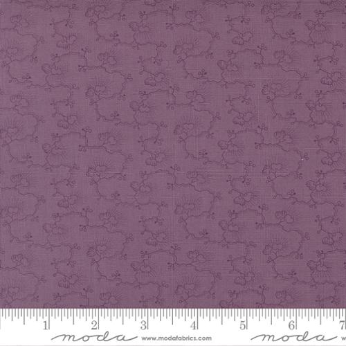 Purple fabric with a subtle pattern and a ruler at the bottom for scale.