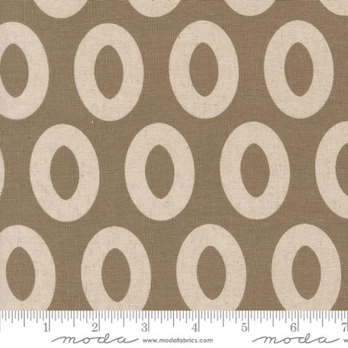 Fabric with grey and white circular pattern and Moda label
